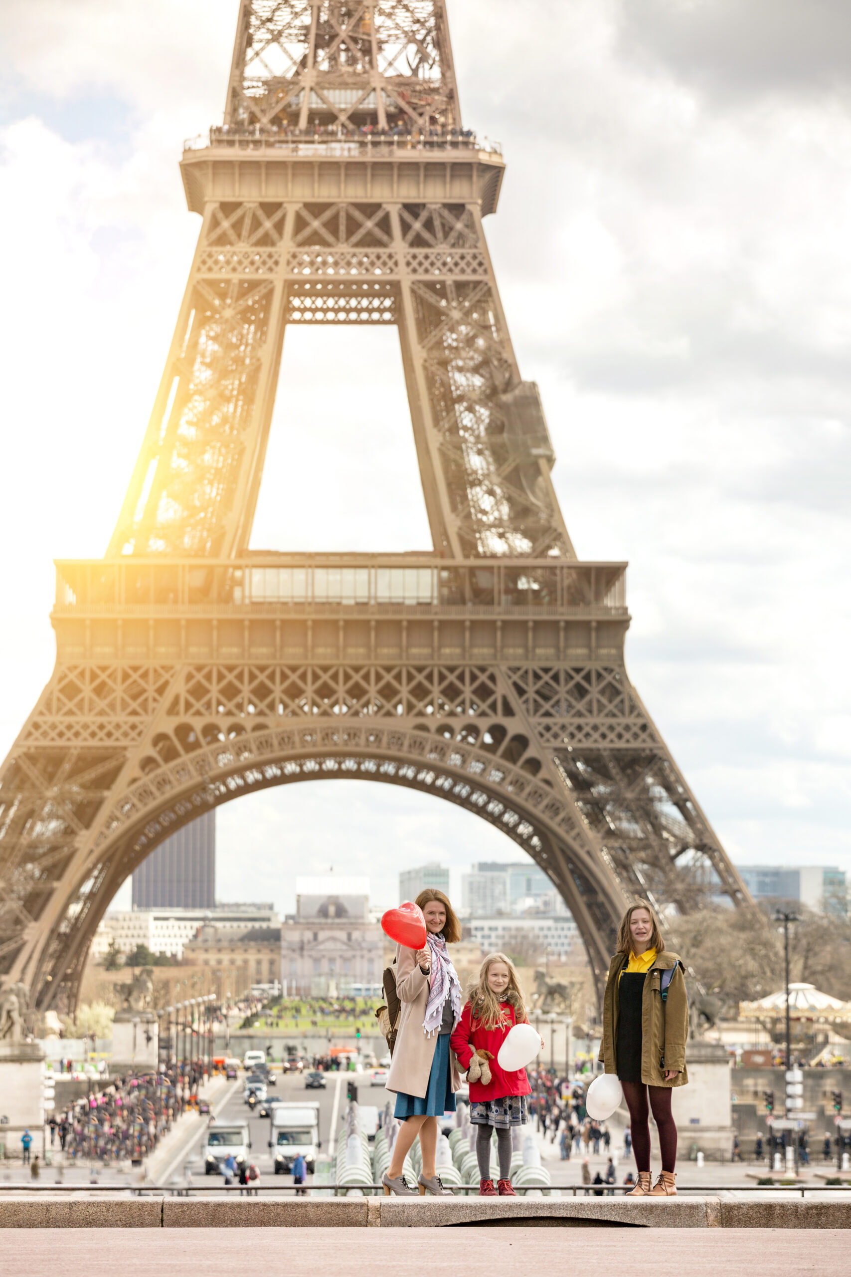 Mom and daughters on the background of the Eiffel Tower